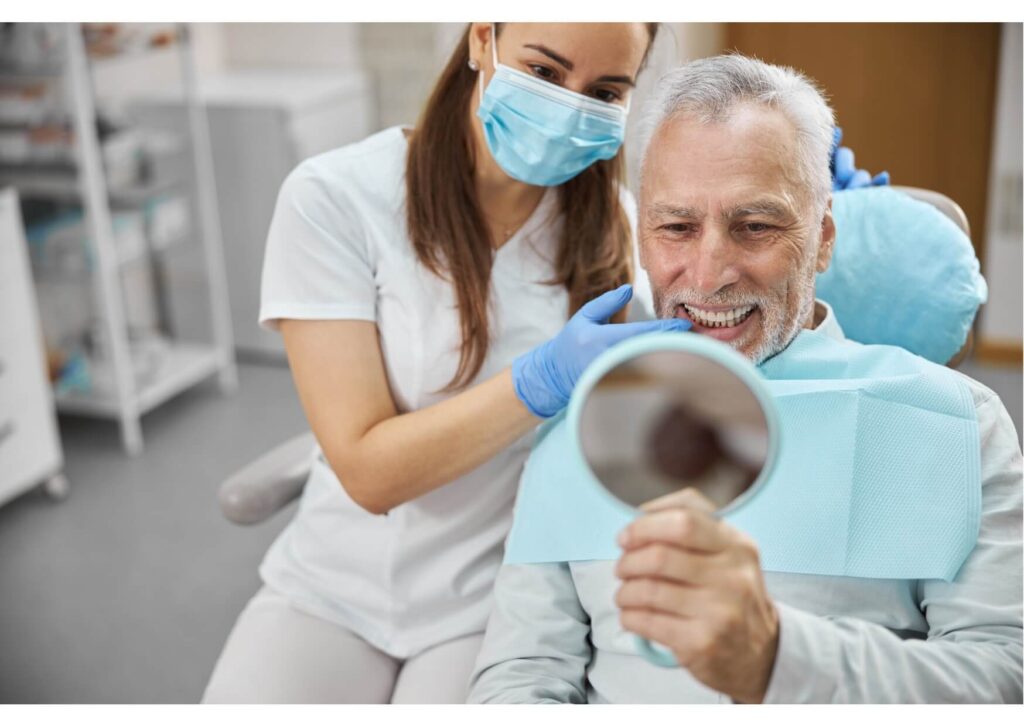 Senior patient reviewing dental implant results with a dentist during a consultation about dental implant costs
