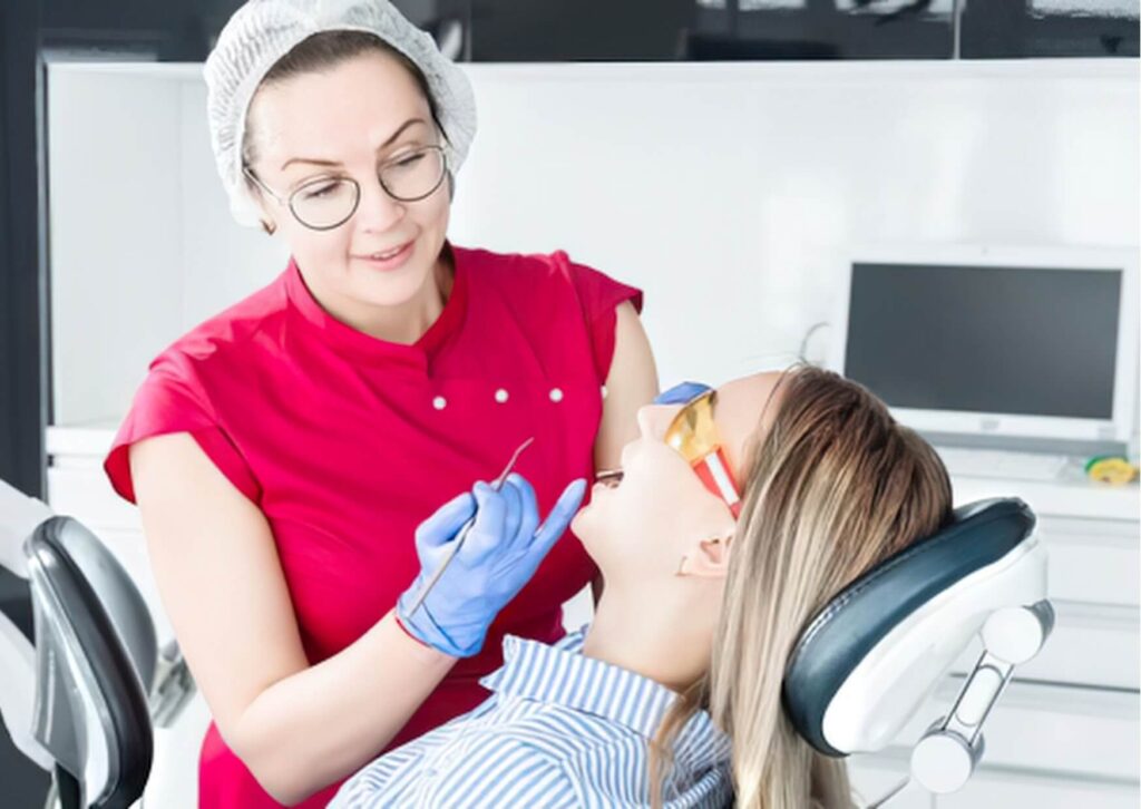 Patient undergoing a root canal procedure while a dentist performs treatment, illustrating the type of dental visit that may affect when it is safe to drive afterward.