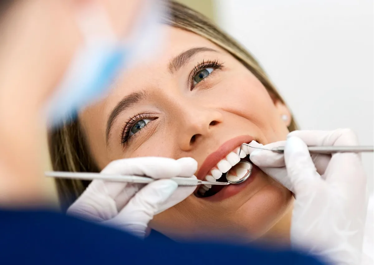 Close-up dental examination of a patient&rsquo;s front teeth before tooth contouring to improve tooth shape and symmetry.